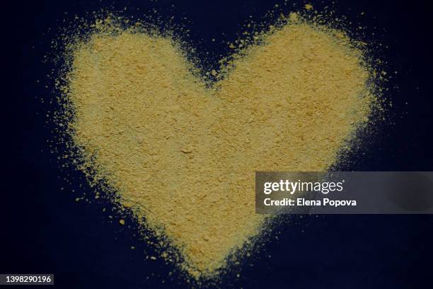 heart shape of nutritional yeast flakes - yeast stock pictures, royalty-free photos & images