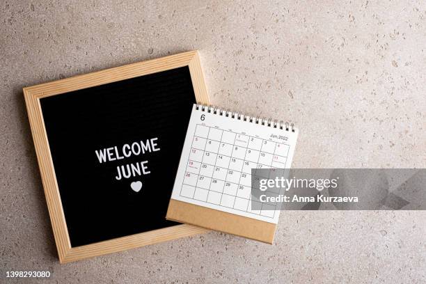 close-up of letter board with text “welcome june” and june 2022 desk calendar, top view. hello summer concept. - monday quotes stock pictures, royalty-free photos & images