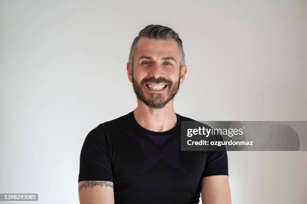 portrait of smiling handsome man looking at camera over white background - 40 year old male models stock pictures, royalty-free photos & images