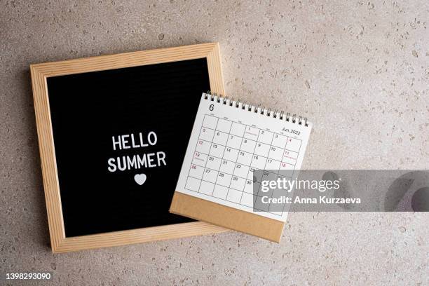 close-up of letter board with text “hello summer” and june 2022 desk calendar, top view. hello summer concept. - monday quotes stock pictures, royalty-free photos & images