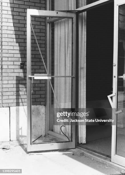 Shattered glass door with riddled bullet holes in Alexander Hall after Jackson city police and the Mississippi highway patrol fired aimlessly into...