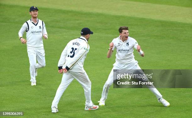 Warwickshire bowler Henry Brookes celebrates with team mates after taking the wicket of Joe Root during the LV= Insurance County Championship match...