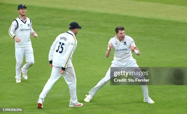 Warwickshire bowler Henry Brookes celebrates with team mates after taking the wicket of Joe Root during the LV= Insurance County Championship match...