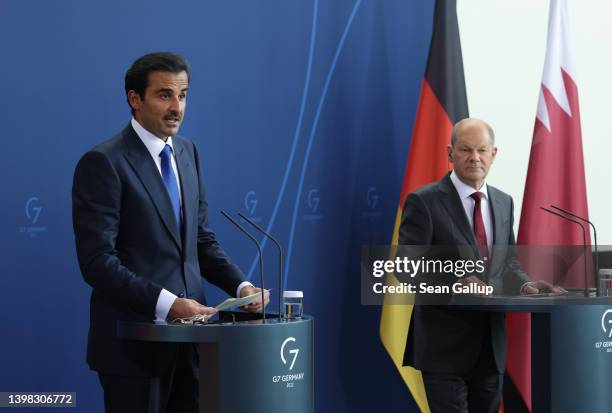 German Chancellor Olaf Scholz and Sheikh Tamim bin Hamad al Thani, Emir of Qatar, speak to the media following talks at the Chancellery on May 20,...