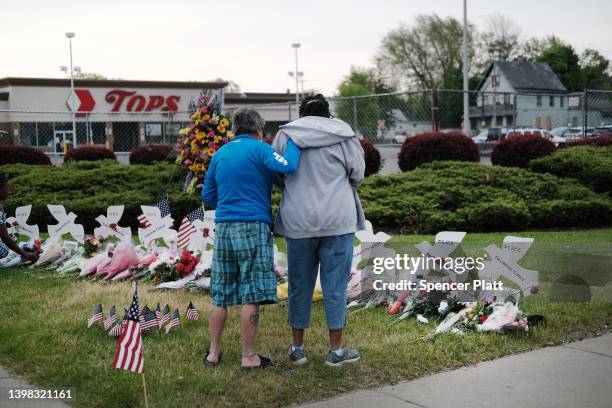 People gather at a memorial for the shooting victims outside of Tops market on May 20, 2022 in Buffalo, New York. 18-year-old Payton Gendron is...