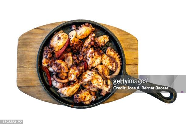grilled octopus served in a frying pan on a white background. - corralejo stock pictures, royalty-free photos & images