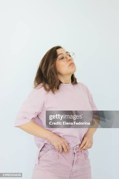 young woman examines her figure. - woman-looking-into-mirror-full-body stock pictures, royalty-free photos & images
