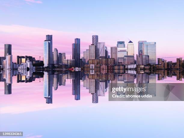 mirror image of london canary wharf skyline at dusk - digital composite - canary wharf bildbanksfoton och bilder