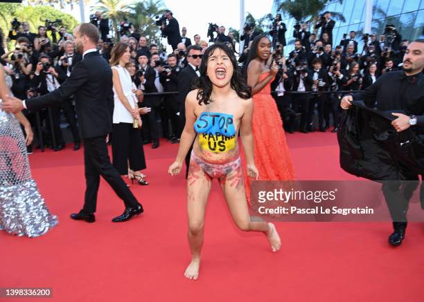 Protester makes her way onto the red carpet during the "Three Thousand Years Of Longing " Red Carpet during the 75th annual Cannes film festival at...