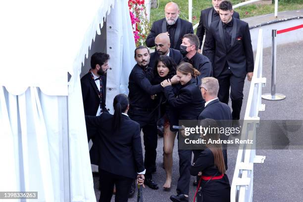 Security remove a protester from the red carpet during the "Three Thousand Years Of Longing " Red Carpet during the 75th annual Cannes film festival...