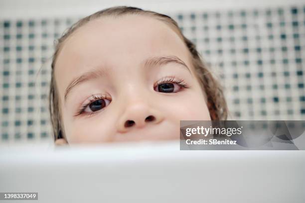 little girl with conjunctivitis during bath - conjunctivitis stock pictures, royalty-free photos & images
