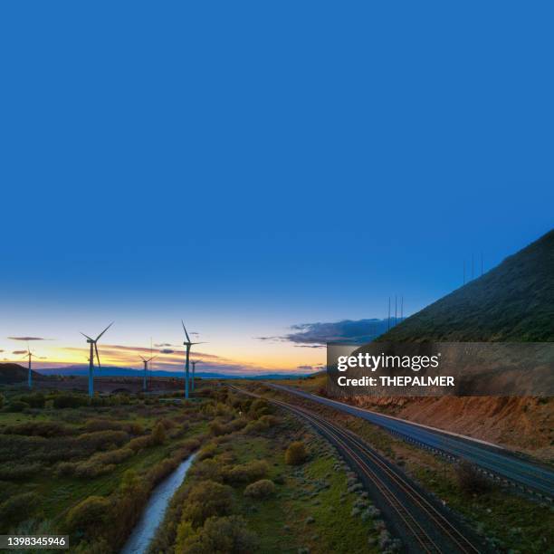 wind farm, rail road and highway - utah, usa - railway tracks sunset stock pictures, royalty-free photos & images