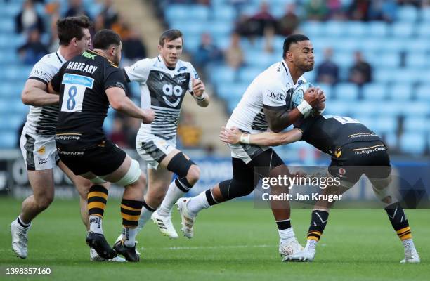 Manu Tuilagi of Sale Sharks runs with the ball into Charlie Atkinson of Wasps during the Gallagher Premiership Rugby match between Wasps and Sale...