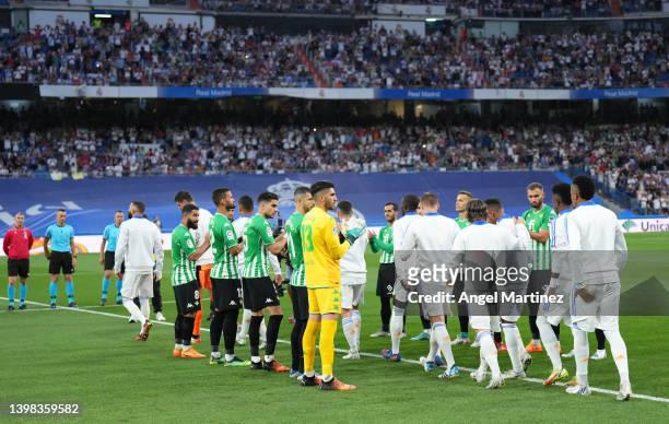 Real Madrid players are given a guard of honour by Real Betis prior to the LaLiga Santander match between Real Madrid CF and Real Betis at Estadio...