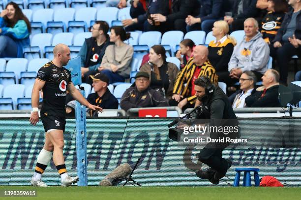 Dan Robson of Wasps helps up a cameraman during the Gallagher Premiership Rugby match between Wasps and Sale Sharks at The Coventry Building Society...