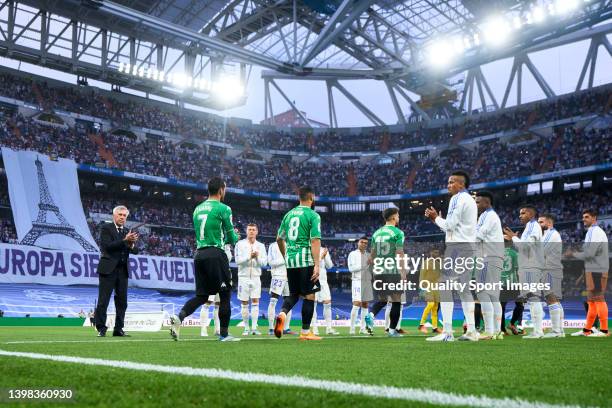 Players of Real Madrid CF line up on the sides to salute players of Real Betis during the LaLiga Santander match between Real Madrid CF and Real...