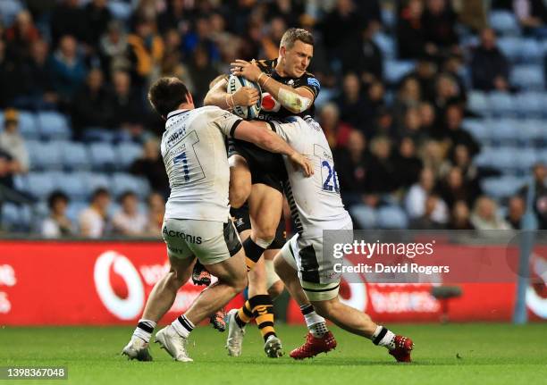 Jimmy Gopperth of Wasps is tackled by Tom Curry and Ben Curry of Sale Sharks during the Gallagher Premiership Rugby match between Wasps and Sale...