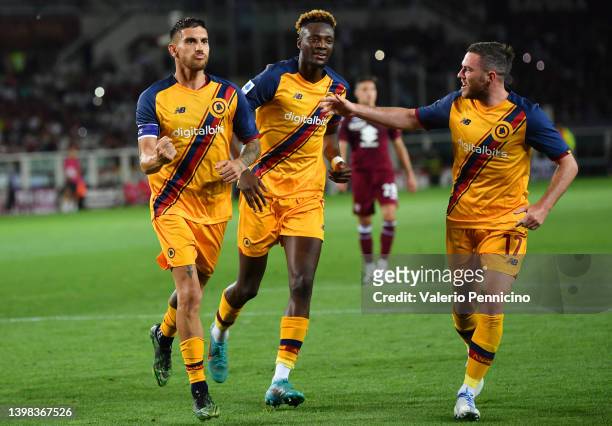 Lorenzo Pellegrini of AS Roma celebrates with teammates Tammy Abraham and Jordan Veretout after scoring their team's third goal from the penalty spot...