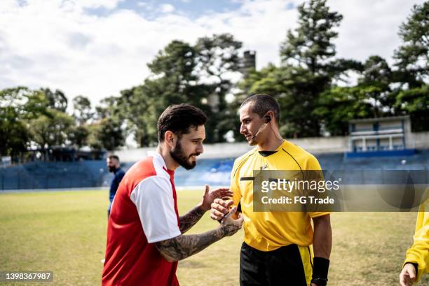 soccer player greeting referee before a match - sport referee stock pictures, royalty-free photos & images