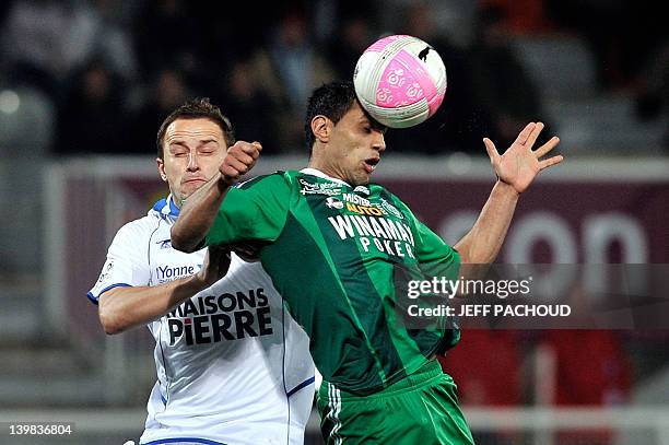 Saint Etienne's Romanian midfielder Banel Nicolita vies with Auxerre's Polish midfielder Dariusz Dudka during the French L1 football match Auxerre vs...