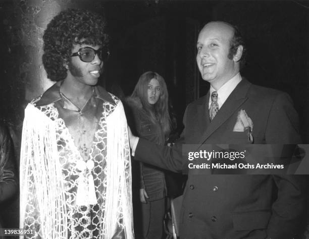 Musician Sly Stone of the psychedelic soul group "Sly And The Family Stone" poses for a portrait with record executive Clive Davis in 1970.