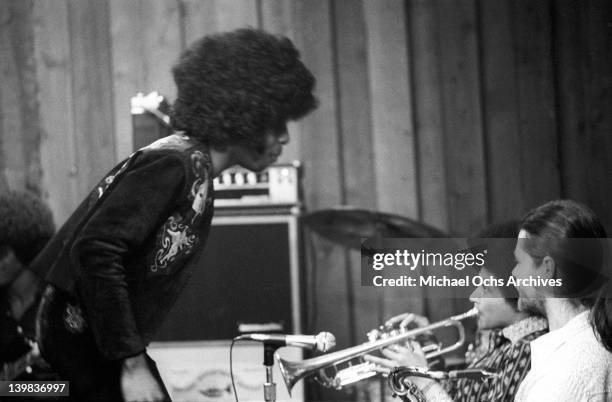 Sly Stone, Cynthia Robinson and Jerry Martini of the psychedelic soul group 'Sly and the Family Stone' record in the studio on April 3, 1973 in San...