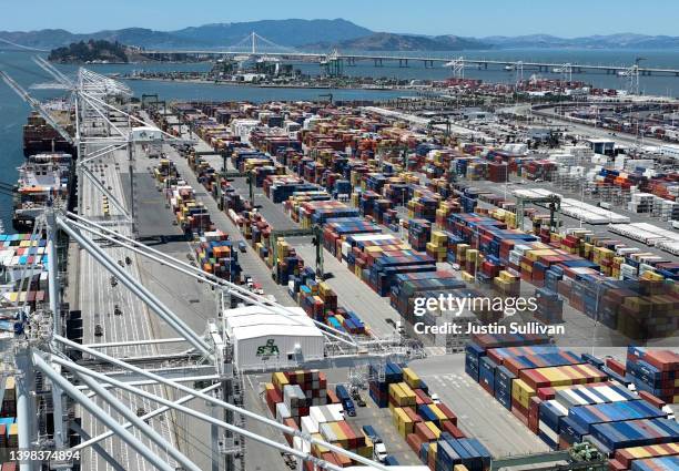 In an aerial view, shipping containers sit on the dock at the Port of Oakland on May 20, 2022 in Oakland, California. As China begins to lift...