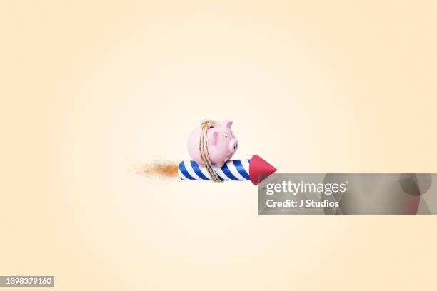 piggy bank taking flight on fireworks - missile launch stock pictures, royalty-free photos & images