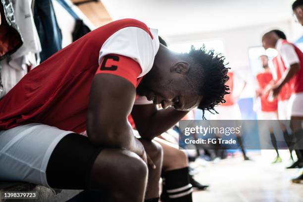 worried soccer player in the locker room - team captain sport stock pictures, royalty-free photos & images