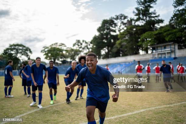 soccer player celebrating a goal - playing sports stock pictures, royalty-free photos & images