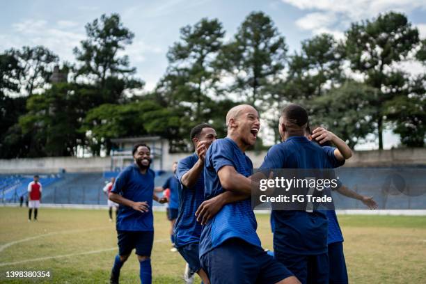 soccer players celebrating a goal - sports strip stock pictures, royalty-free photos & images