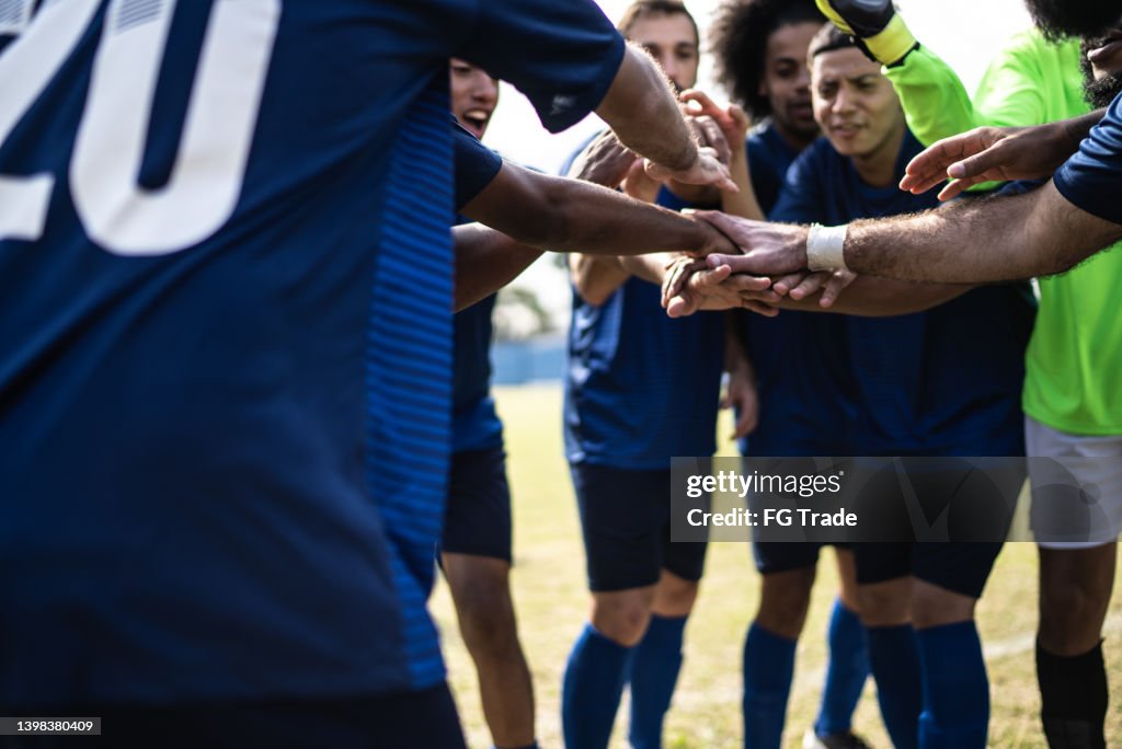 Soccer team huddling before a match