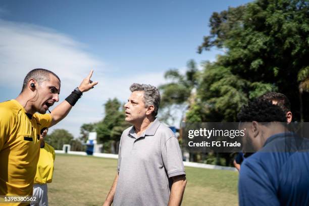 soccer players and coach complaining to referee during match - angry coach stock pictures, royalty-free photos & images