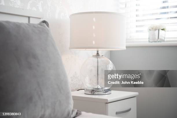 property bedroom interiors - bedside table lamp stock pictures, royalty-free photos & images