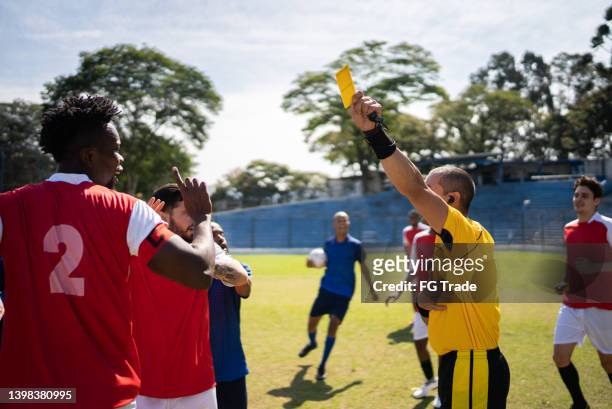 referee showing yellow card - soccer referee stock pictures, royalty-free photos & images