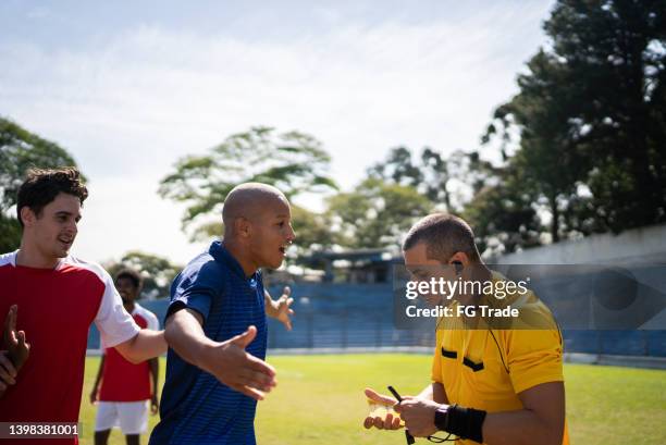 soccer players complaining with referee during the match - var referee stock pictures, royalty-free photos & images