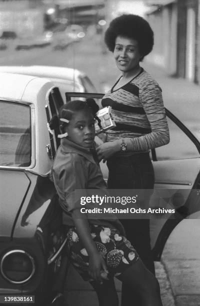 Laura Marie and her mother Cynthia Robinson of the psychedelic soul group 'Sly And The Family Stone' stand next to a car on April 3, 1973 in San...