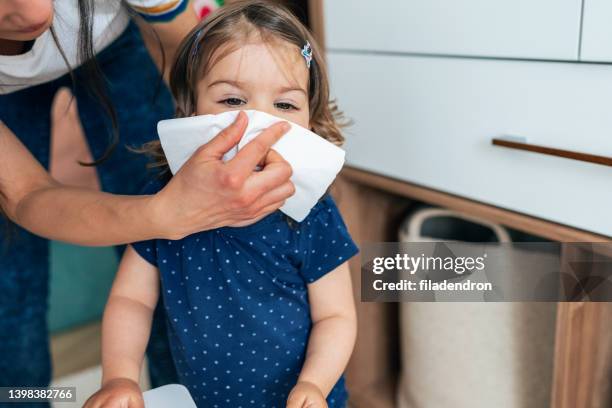 mother blow child's nose - blowing nose stock pictures, royalty-free photos & images