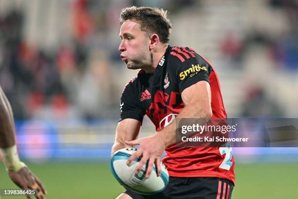 Fergus Burke of the Crusaders passes the ball during the round 14 Super Rugby Pacific match between the Crusaders and the Fijian Drua at Orangetheory...