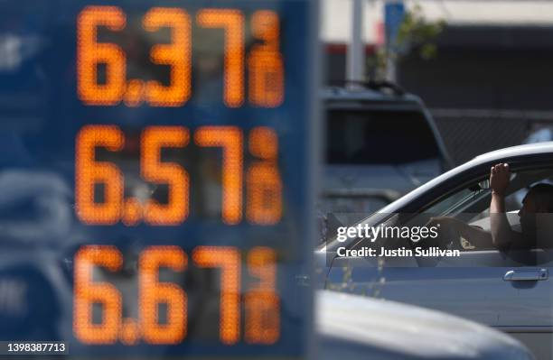 Driver passes a sign with gas prices over $6.00 per gallon on May 20, 2022 in San Rafael, California. Gas prices in California have surpassed $6.00...