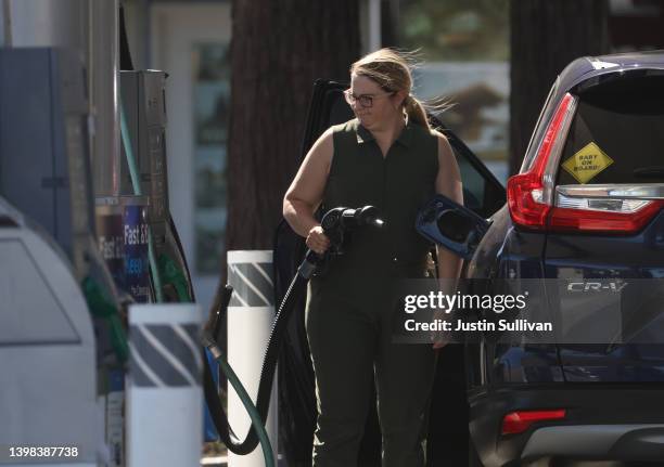 Customer prepares to pump gas into her car at a Chevron gas station on May 20, 2022 in San Rafael, California. Gas prices in California have...