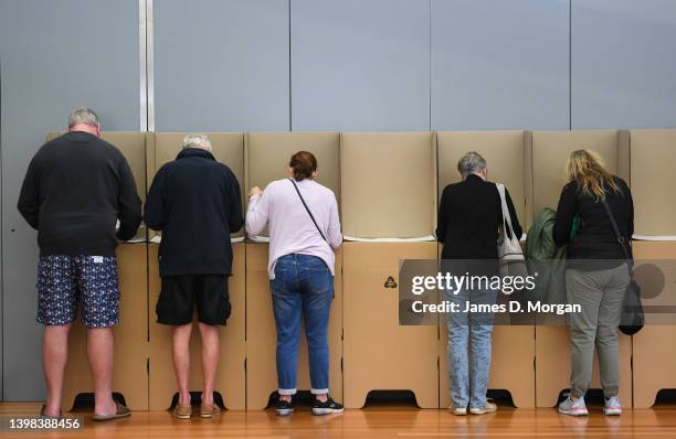 Voters stand at ballot booths to cast their votes inside Mona Vale Memorial Hall in the electorate of Mackellar on May 21, 2022 in Sydney, Australia....