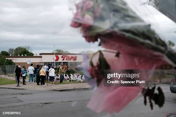 People gather at a memorial for the shooting victims outside of Tops grocery store on May 20, 2022 in Buffalo, New York. 18-year-old Payton Gendron...