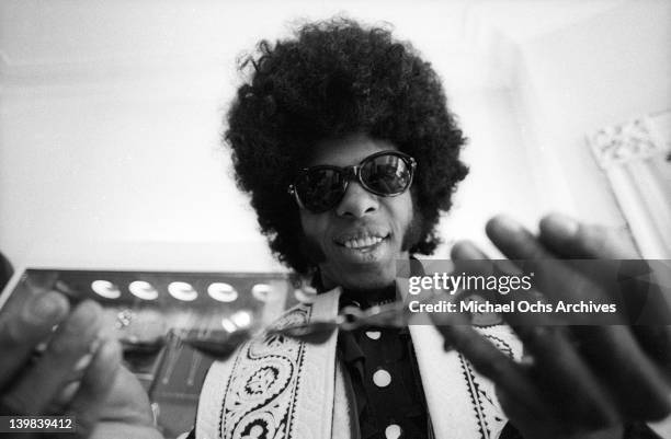 Sly Stone of the psychedelic soul group 'Sly And The Family Stone' tries on a necklace on March 9, 1969.