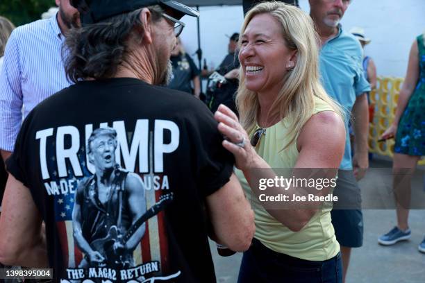 Rep. Marjorie Taylor Greene greets people as she campaigns during a Bikers for Trump event held at the Crazy Acres Bar & Grill on May 20, 2022 in...