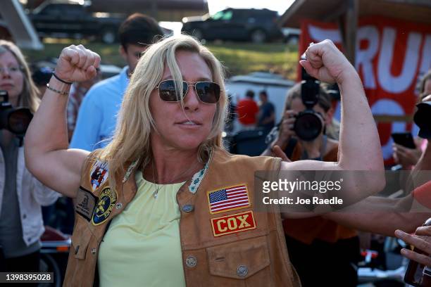 Rep. Marjorie Taylor Greene flexes her muscles during a Bikers for Trump campaign event held at the Crazy Acres Bar & Grill on May 20, 2022 in...