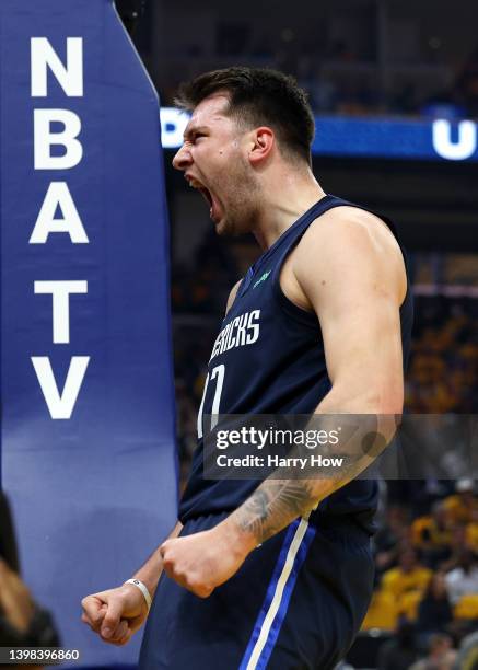 Luka Doncic of the Dallas Mavericks reacts after scoring and drawing a foul by Andrew Wiggins of the Golden State Warriors during the first quarter...