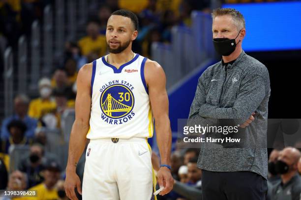 Head coach Steve Kerr and Stephen Curry of the Golden State Warriors look on during the first quarter against the Dallas Mavericks in Game Two of the...
