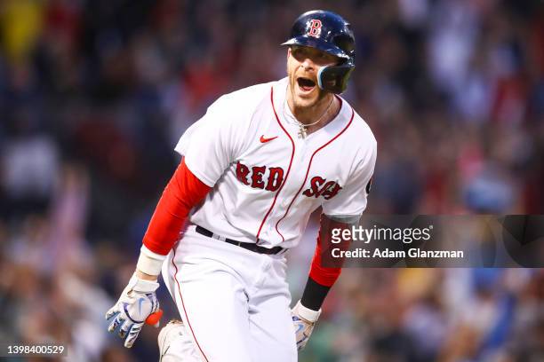 Trevor Story of the Boston Red Sox reacts after hitting a grand slam in the third inning of a game against the Seattle Mariners at Fenway Park on May...