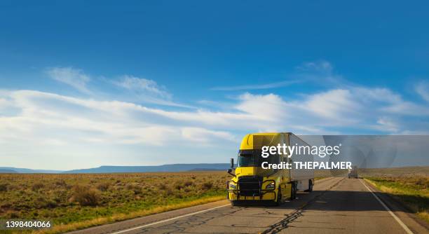 big yellow truck with refrigerated cargo speeding in arizona - panning motion blur - refrigerator truck stock pictures, royalty-free photos & images